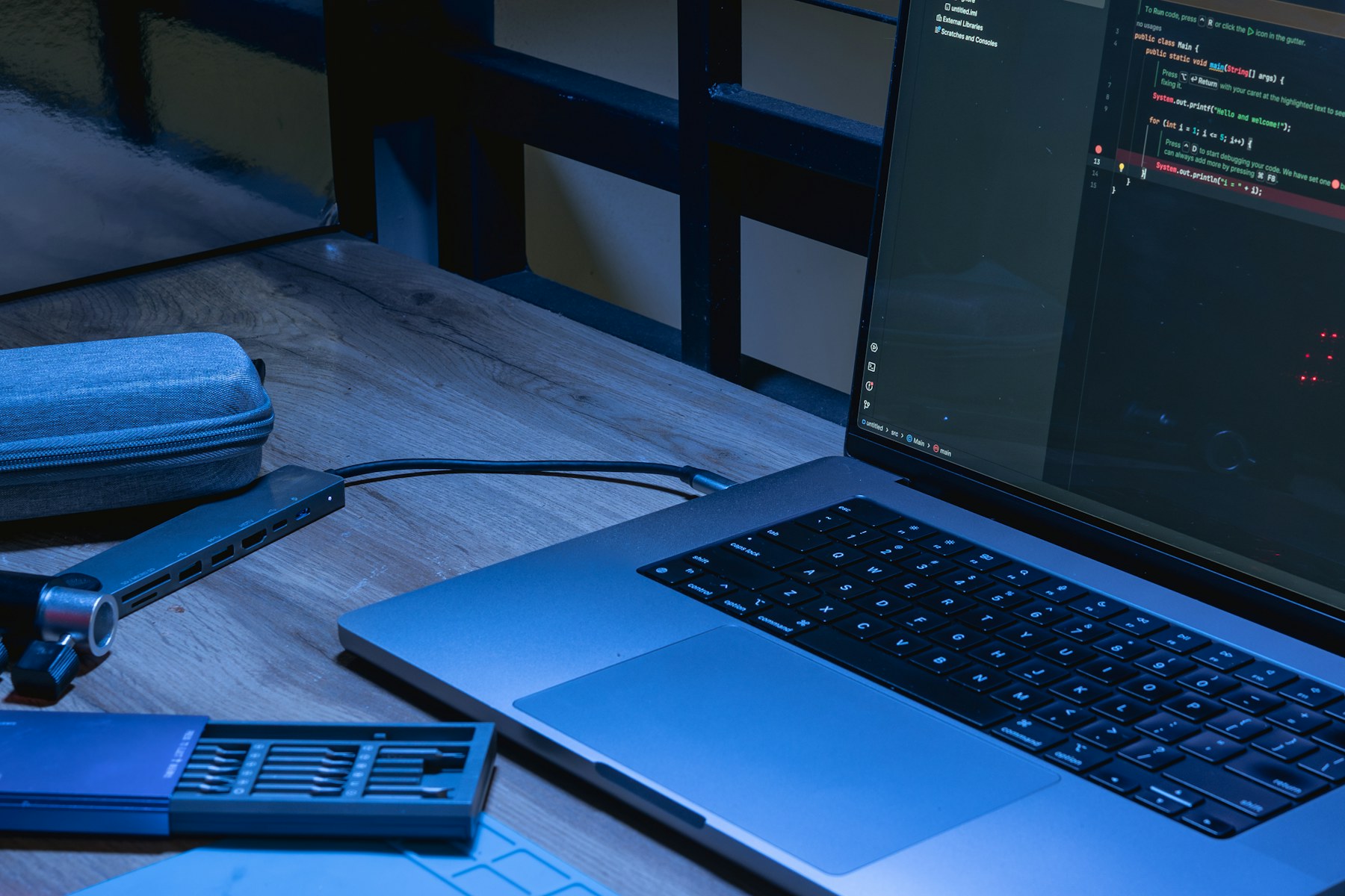 A laptop and phone on a desk with software open